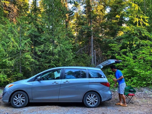 Trin making dinner behind our Mazda 5