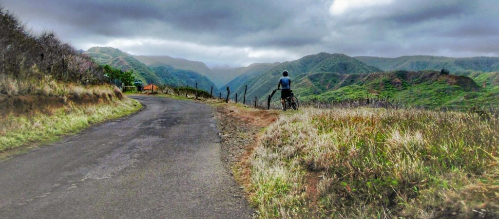 Trin on a bicycle next to the road around West Maui